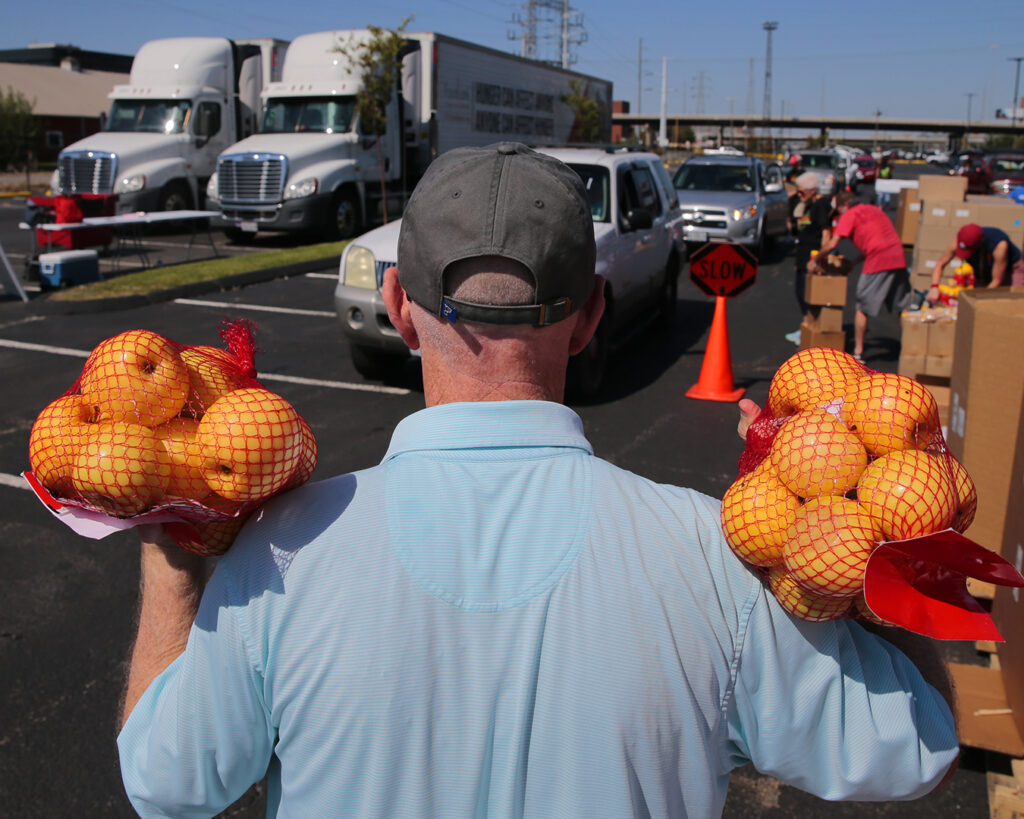 Man holding bags of apples